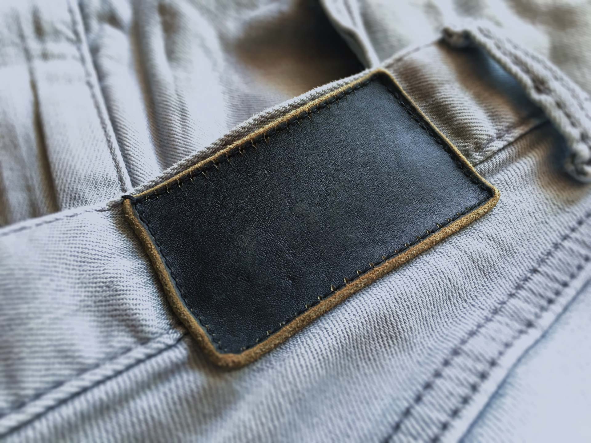 Dark-Leather-Label-Engraved-Logo-Mockup-On-Denim-Blank