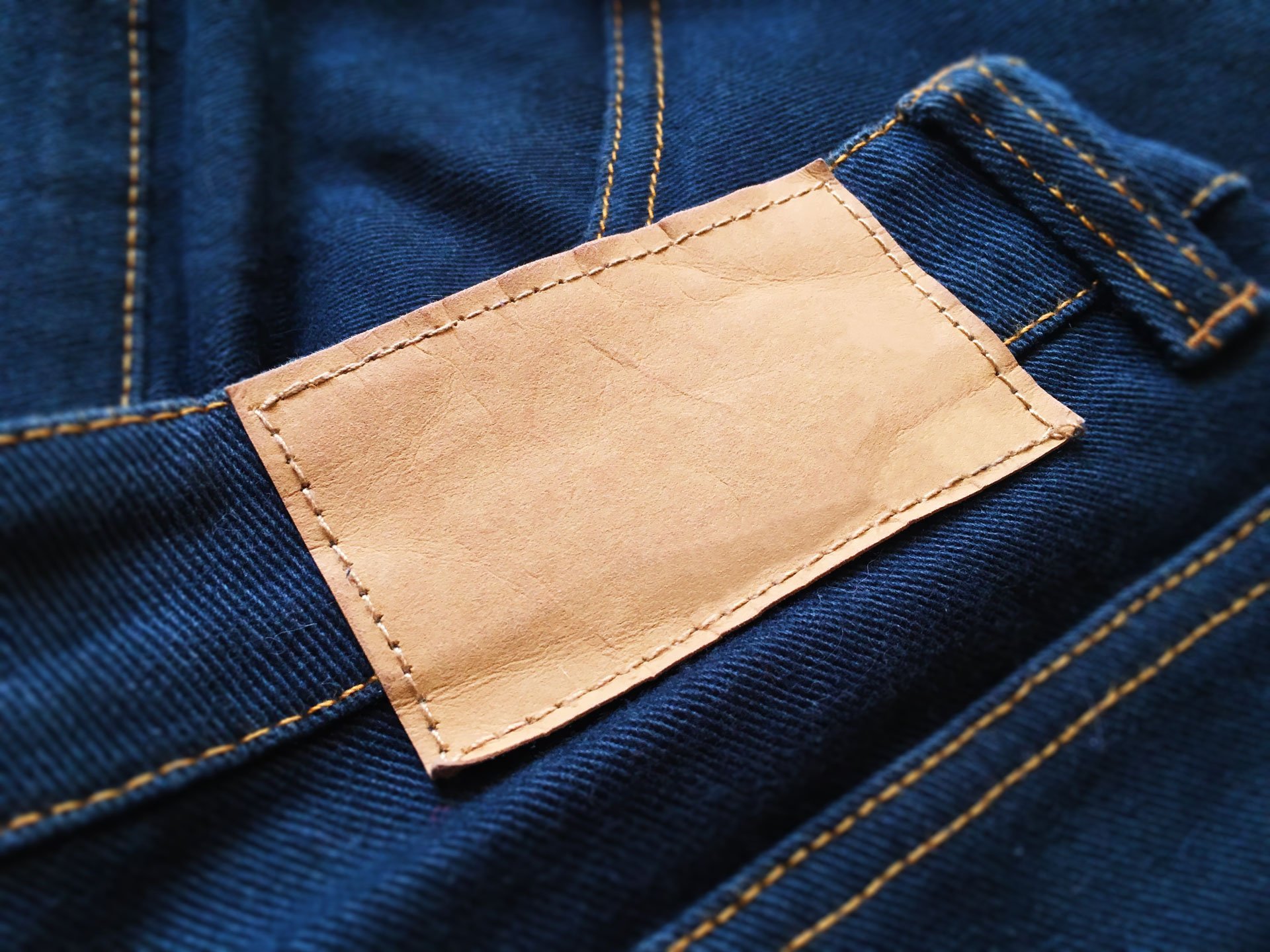 Yellow Paper Label Logo Mockup on Dark Blue Jeans Blank